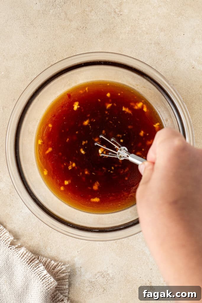 Whisking together the sauce ingredients.