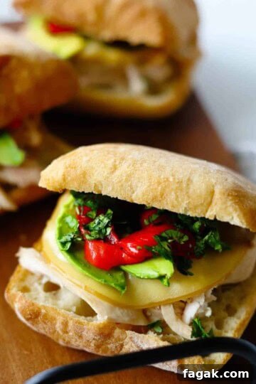 Chipotle chicken avocado melts on wooden platter.