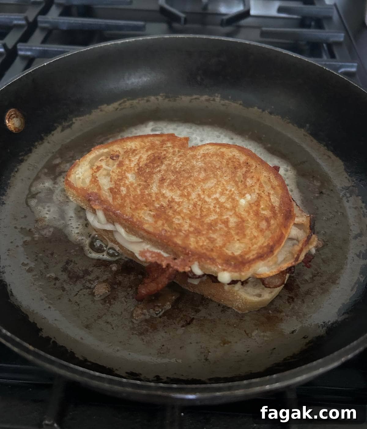 Crispy Bacon Turkey Melt with Cheddar and Garlic Aioli 7 Toasted turkey melt in pan.