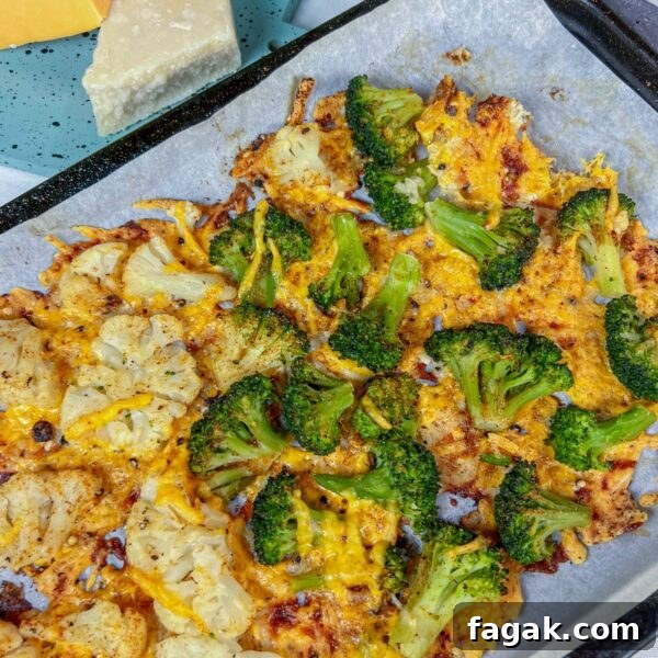 broccoli and cauliflower on baking sheet with crispy cheese baked on