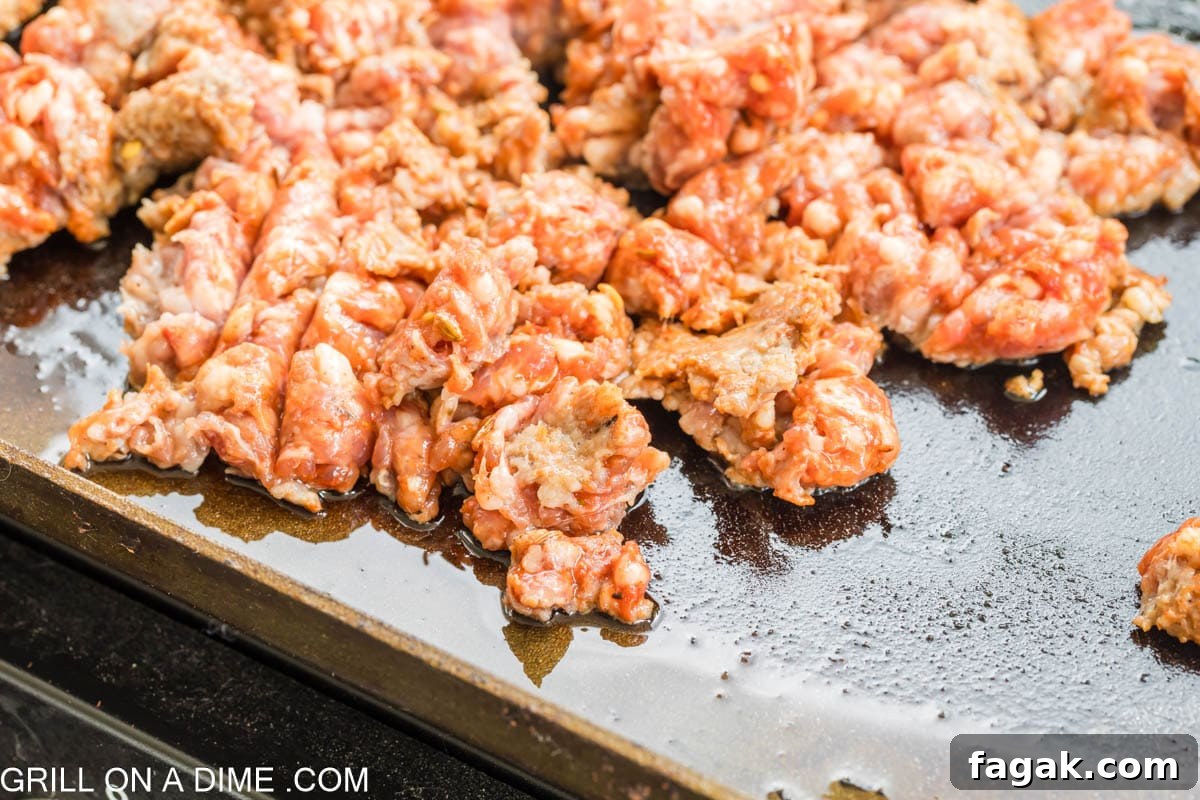 Ground Italian Sausage cooking on the Blackstone Griddle