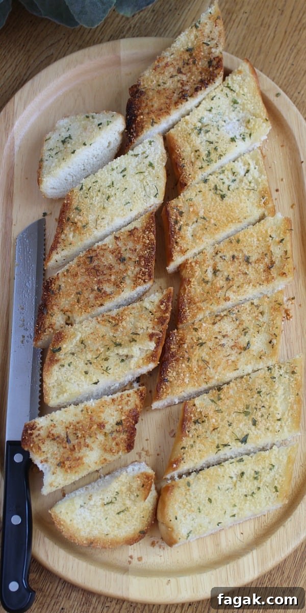 Sliced garlic toast on cutting board.