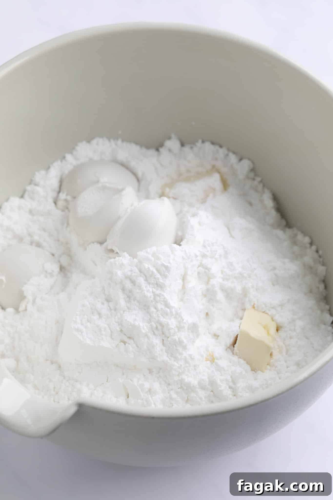 Vegan Peppermint Patties Recipe — Creamy Chocolate Mint Treats 3 powdered sugar, coconut milk, and butter in a large white bowl.