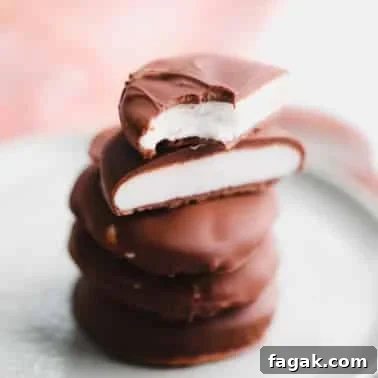 Vegan Peppermint Patties Recipe — Creamy Chocolate Mint Treats 9 a stack of vegan peppermint patties cut in half on a small plate.
