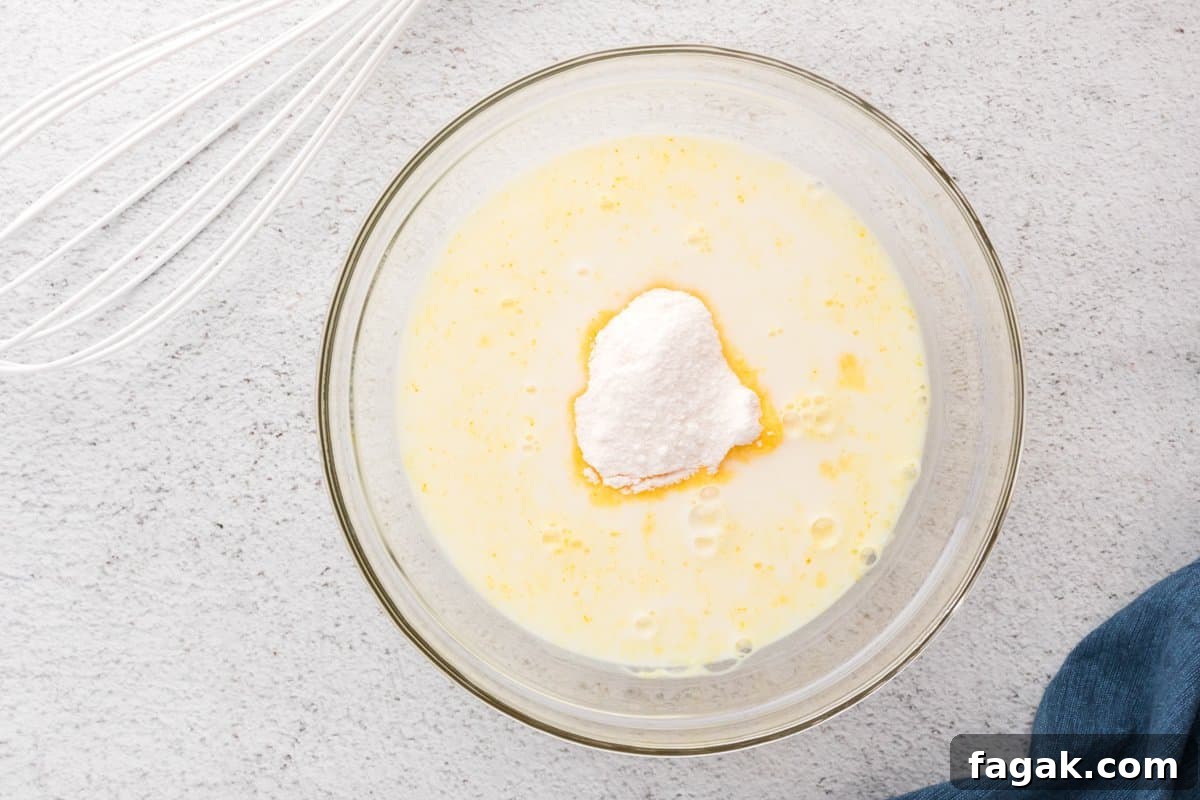 banana pudding mix in a glass bowl filled with milk.