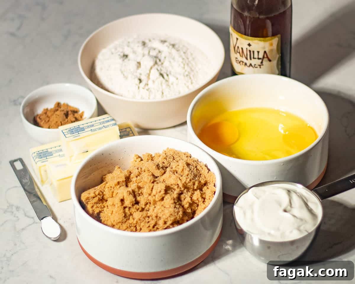 Ingredients laid out for making a chai bundt spice cake, including flour, eggs, brown sugar, vanilla extract, butter, and spices, ready for mixing into the cake batter.