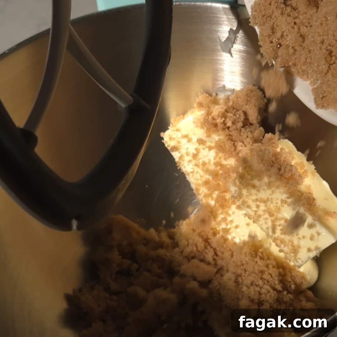 Brown sugar and softened butter being creamed together in a mixer, a crucial step for making the chai bundt spice cake.