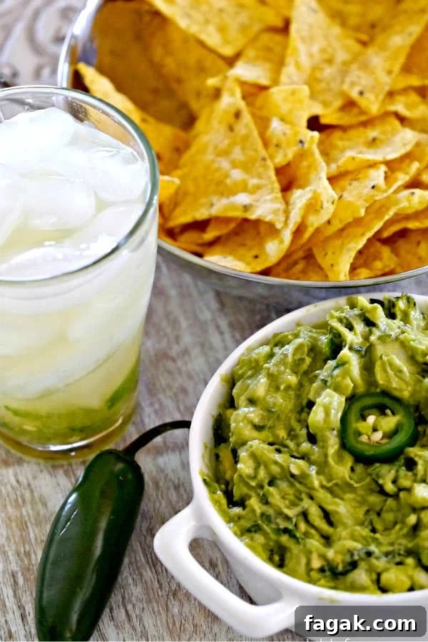 bowl of spicy creamy guacamole just like traditional Mexican recipe for game day