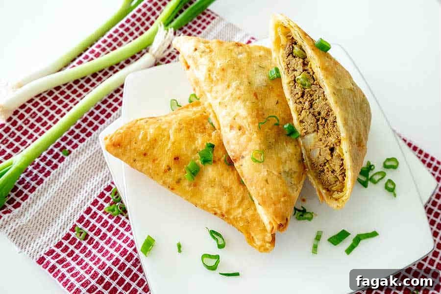 gluten free samosa cut in half on a plate for game day