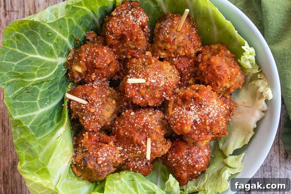 baked Italian meatballs in a bowl lined with cabbage leaf
