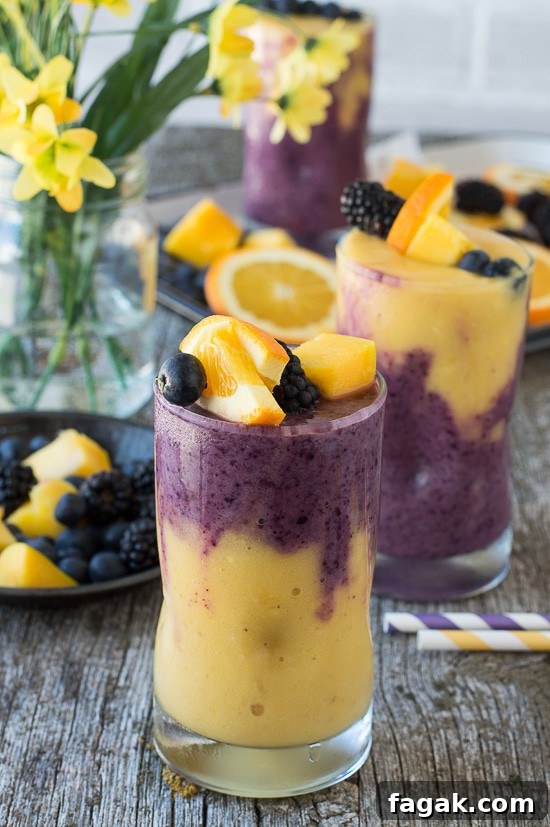 This two layer Hawaiian Berry Smoothie has an orange mango layer and a berry layer! Top the smoothie with a skewer filled with fresh fruit! 