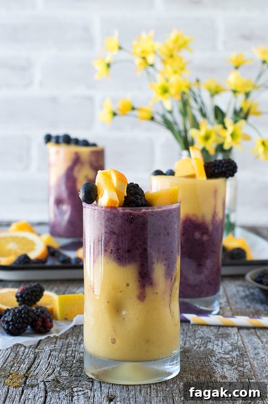 This two layer Hawaiian Berry Smoothie has an orange mango layer and a berry layer! Top the smoothie with a skewer filled with fresh fruit! 
