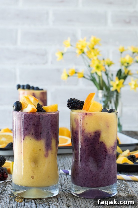 This two layer Hawaiian Berry Smoothie has an orange mango layer and a berry layer! Top the smoothie with a skewer filled with fresh fruit! 