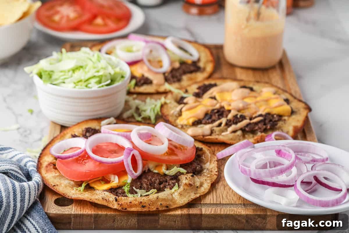 Smash Burger Tacos with the fixings and burger sauce on wooden platter