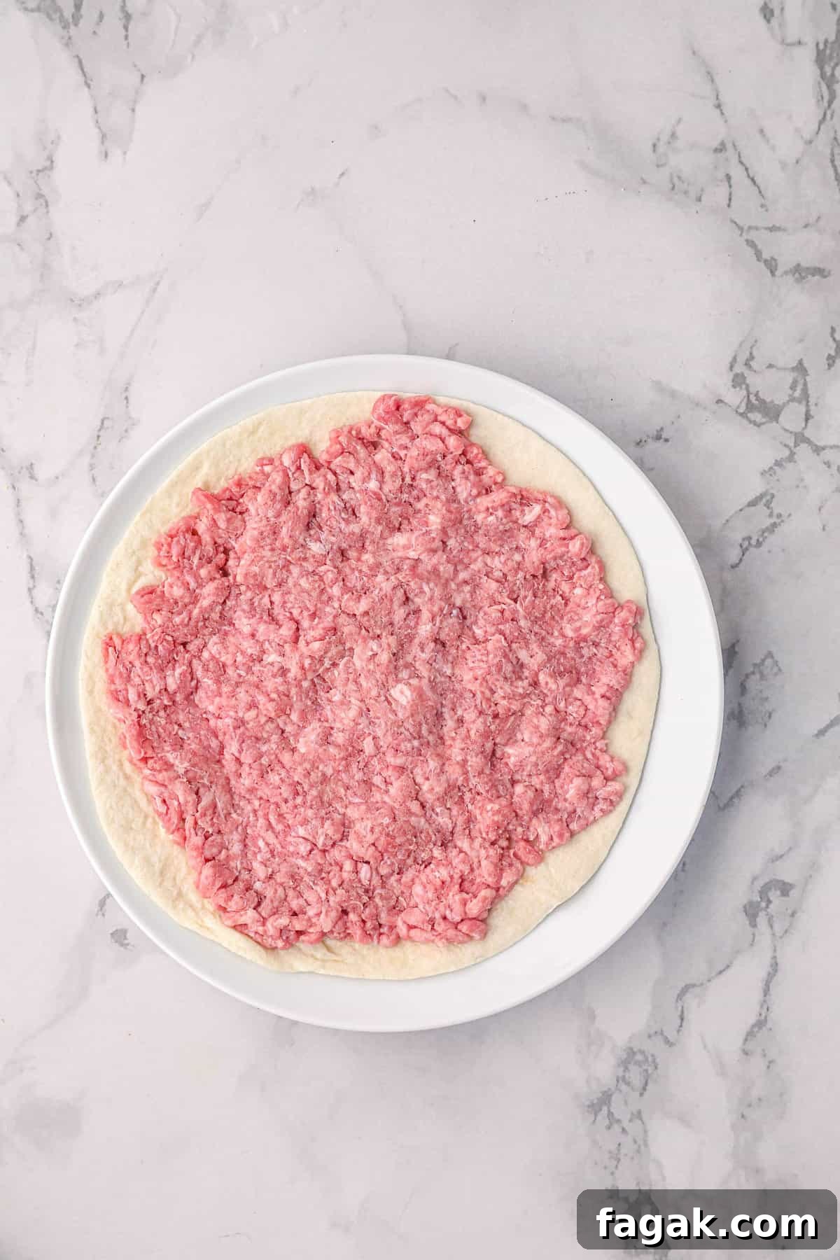 Ground beef on tortilla for Smash Burger Taco recipe