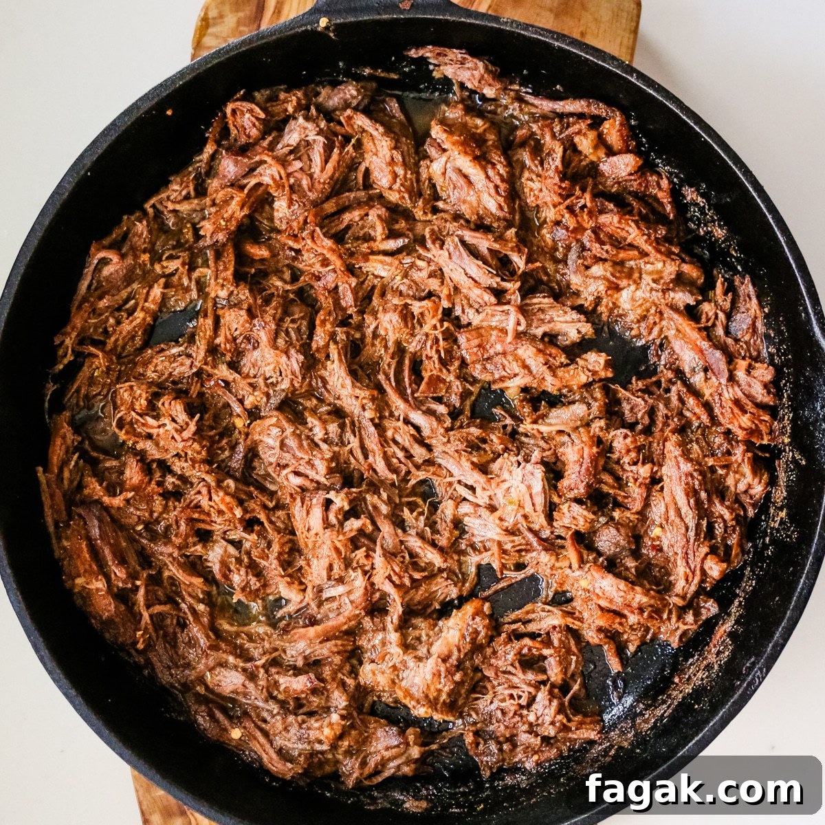 Slow-Braised Chuck Roast Tacos with Salsa Verde 6 Sautéing beef in a pan.