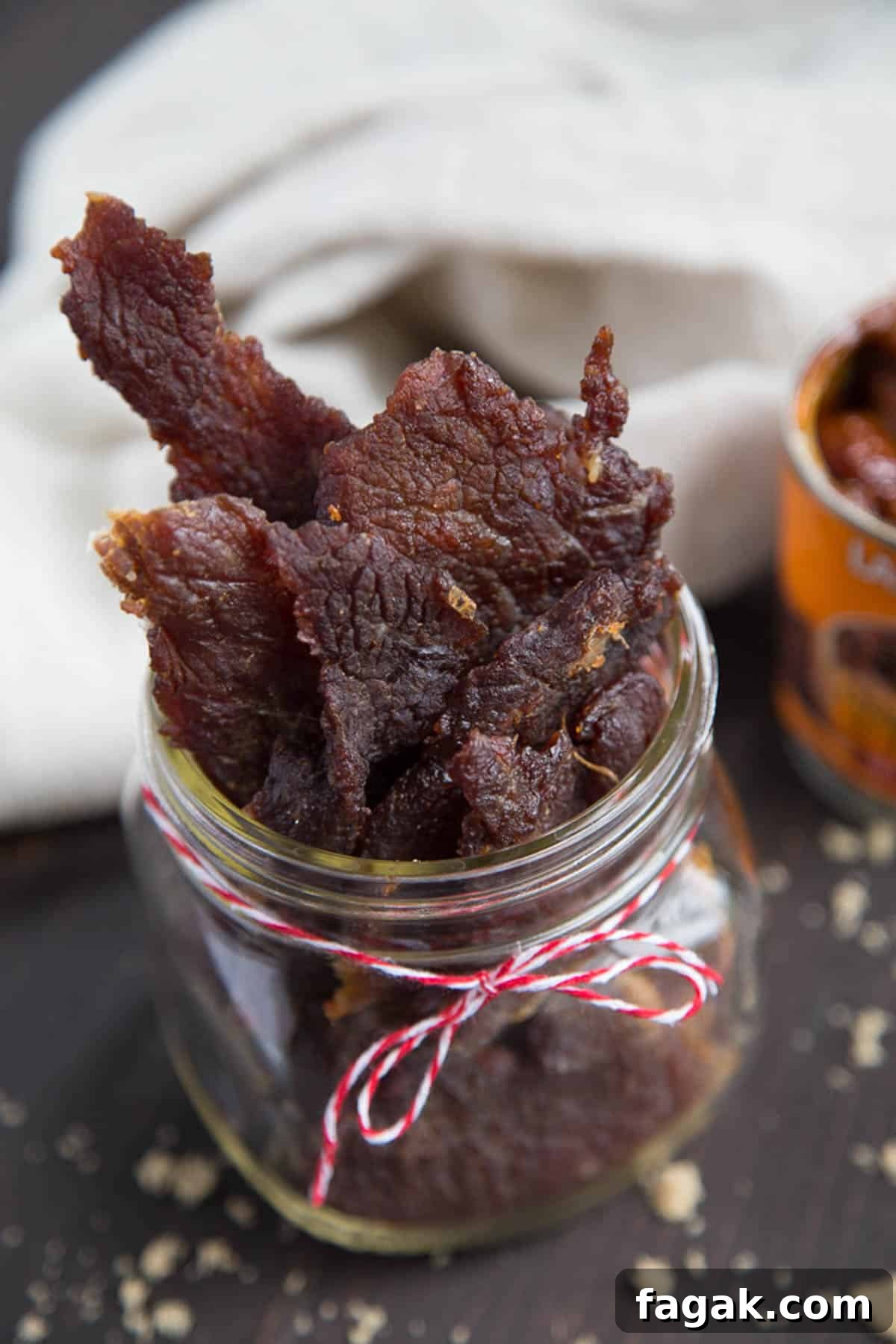 sweet and spicy jerky in a glass mason jar.