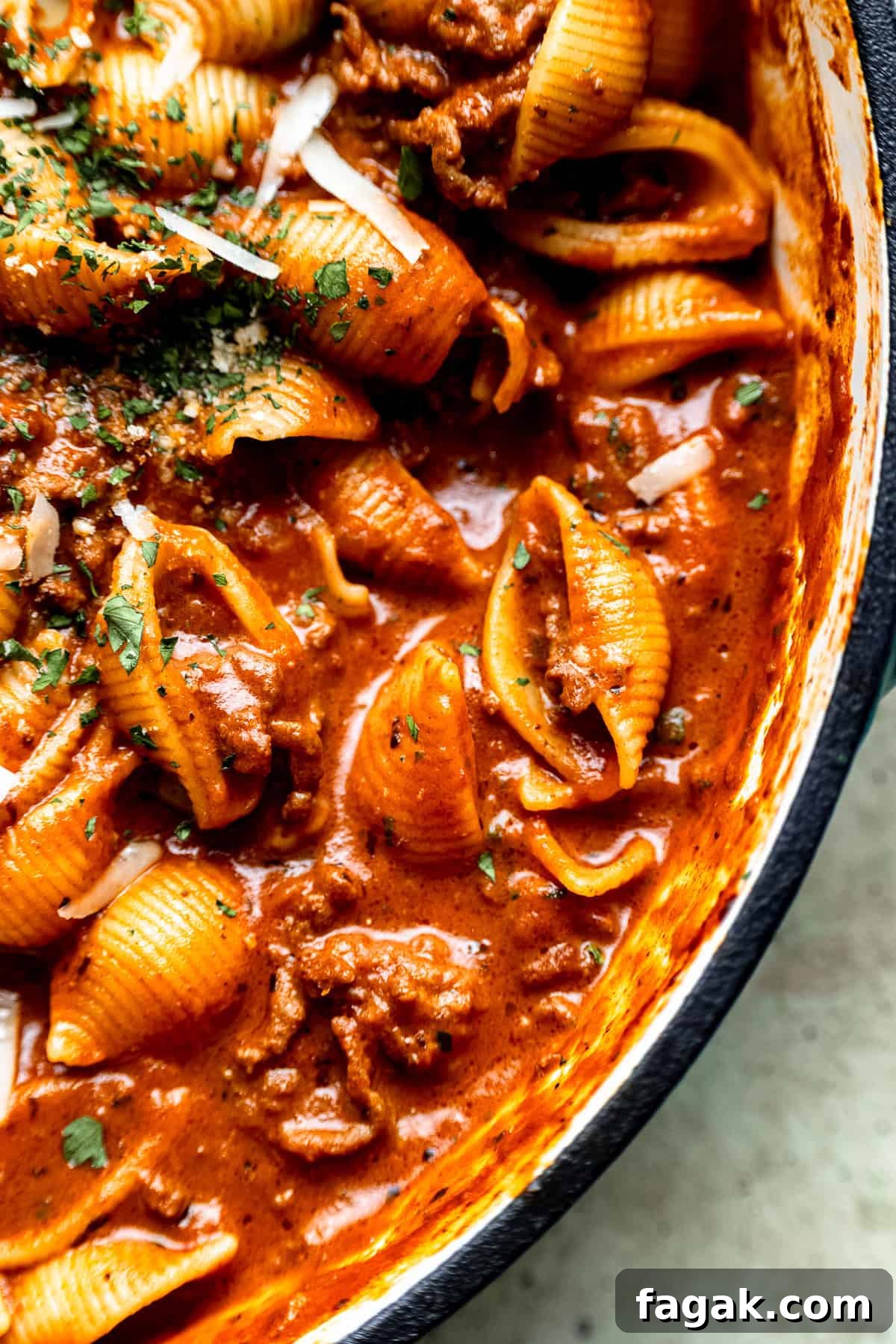 Close up of creamy bolognese and shells pasta.