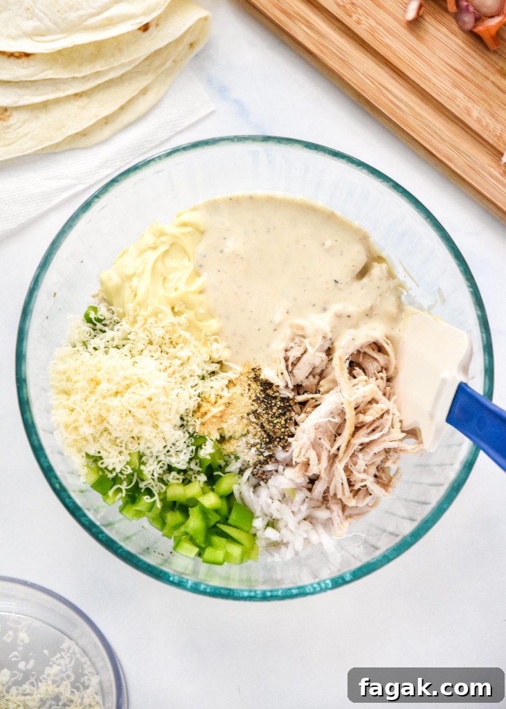ingredients in a glass bowl for the caesar chicken salad lunch wraps before mixing.