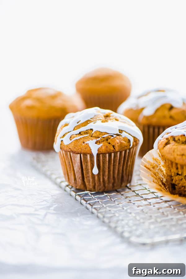 Gluten free sweet potato muffins on a small wire rack topped with marshmallow glaze