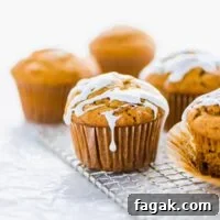 Gluten free sweet potato muffins on a small wire rack topped with marshmallow glaze