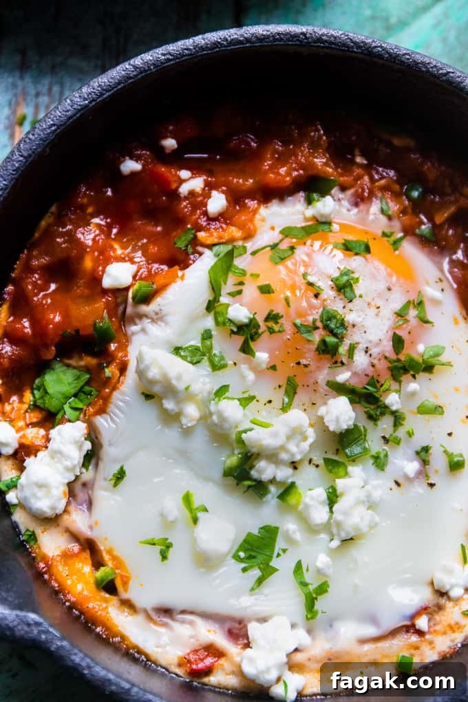 Spicy Turkish Style Baked Eggs (Shakshuka) in a skillet.