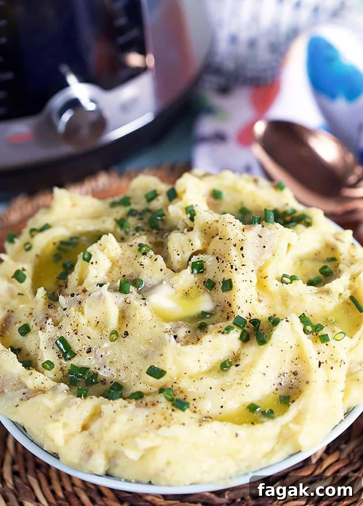 Mashed potatoes in a bowl with an instant pot in the background.