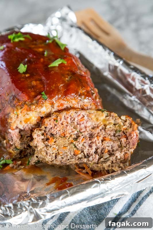 A close up of a piece of cake on a paper plate, with Meatloaf and Dinner