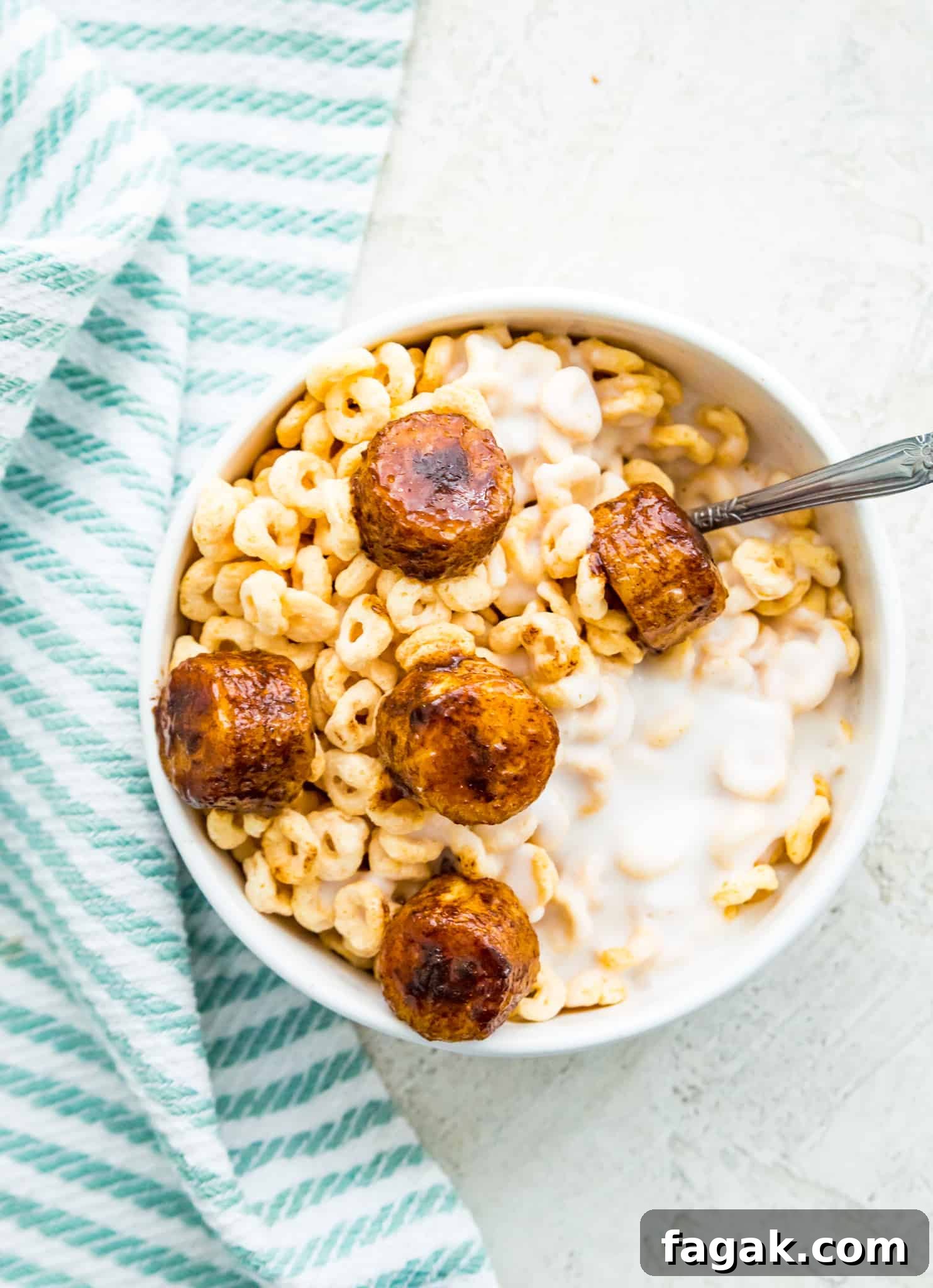 Caramelized Cinnamon Bananas in the Air Fryer 8 Caramelized air fryer bananas on top of a bowl of cereal with milk.