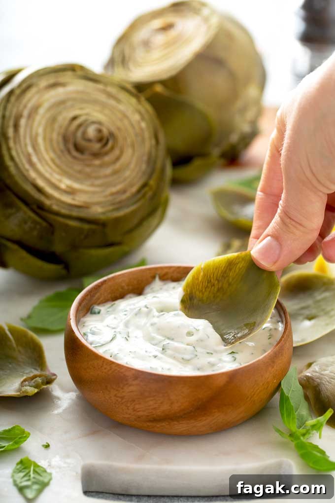 Artichoke leave getting dipped in sauce