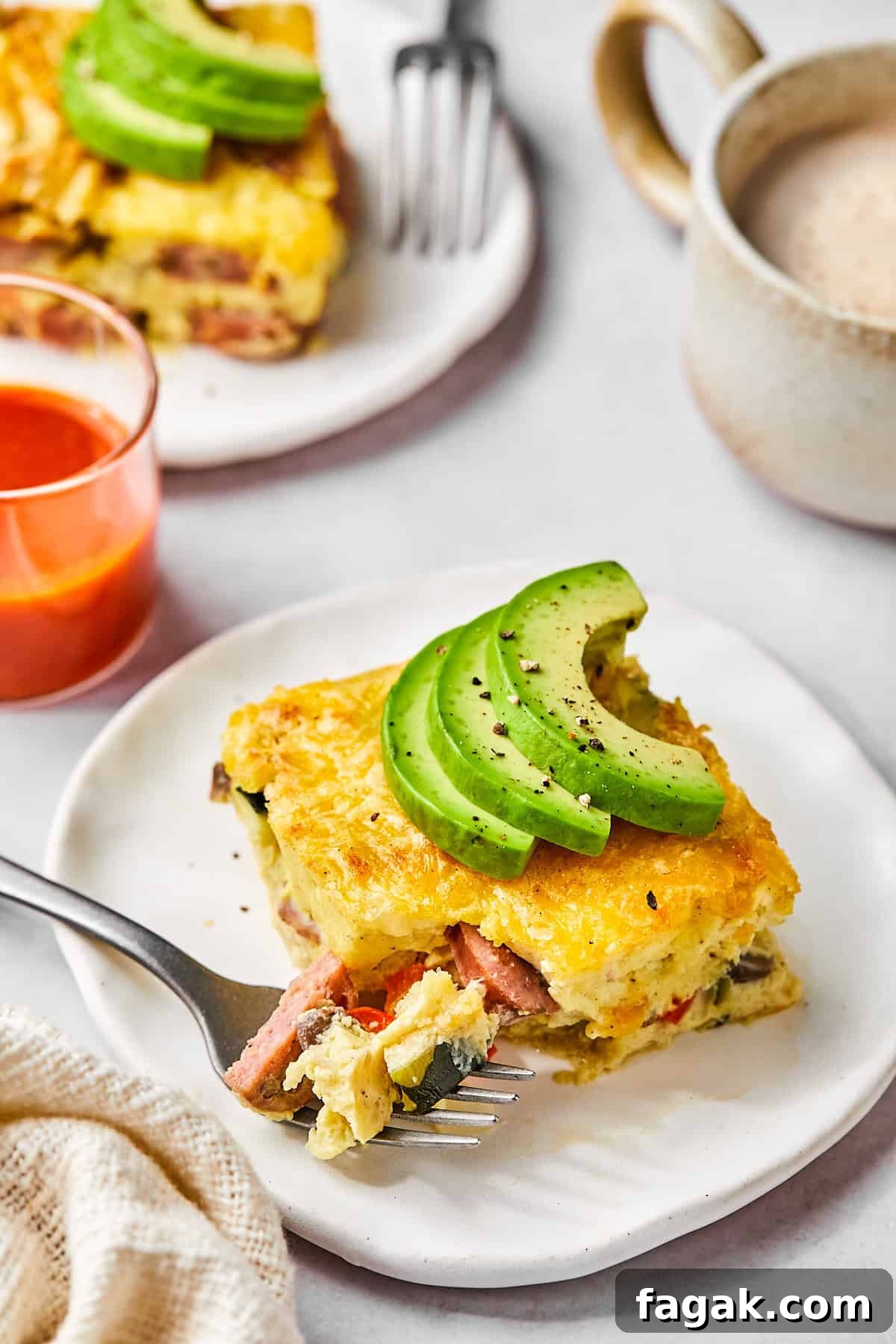Sliced squares of egg bake on a serving plate topped with avocado 