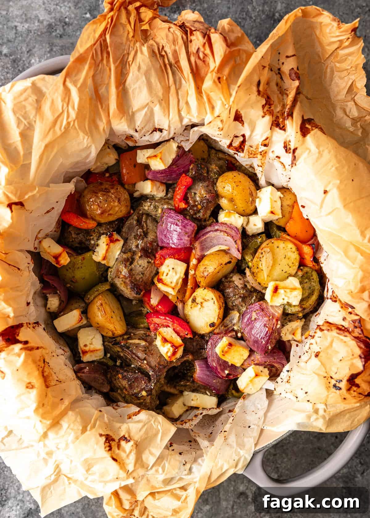 overhead: lamb in parchment with vegetables after roasting