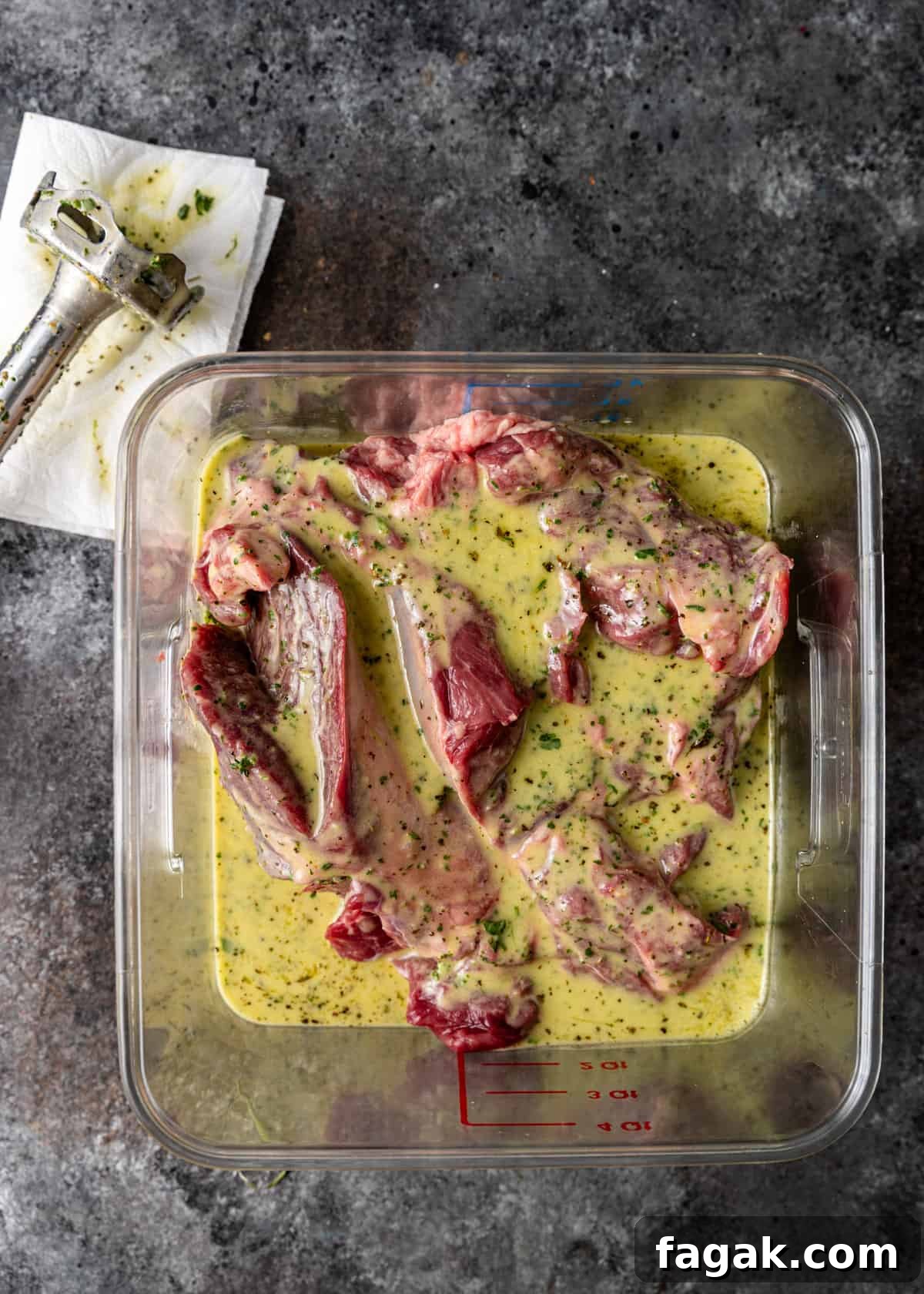 overhead: kleftiko marinating in a large plastic measuring bowl