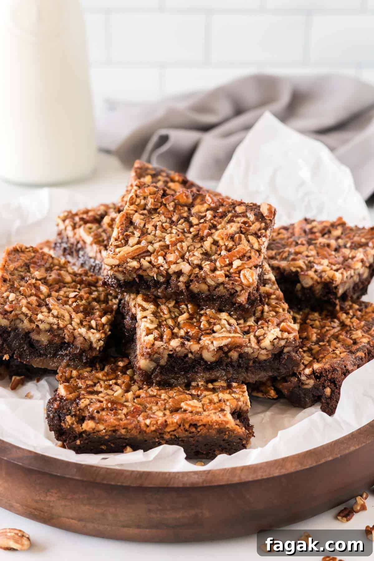 pecan pie brownies cut into squares and stacked on a plate