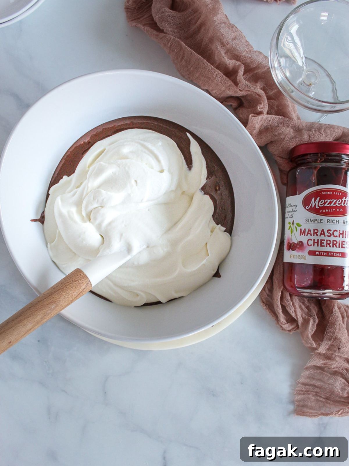 folding whipped cream into a bowl with melted chocolate.