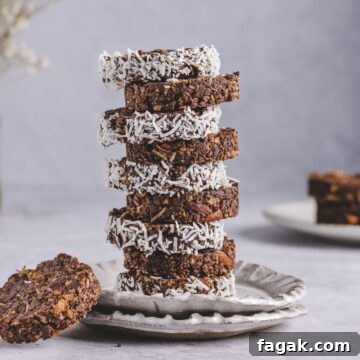 a photo of stacked cornflake cakes garnished with coconut shreds
