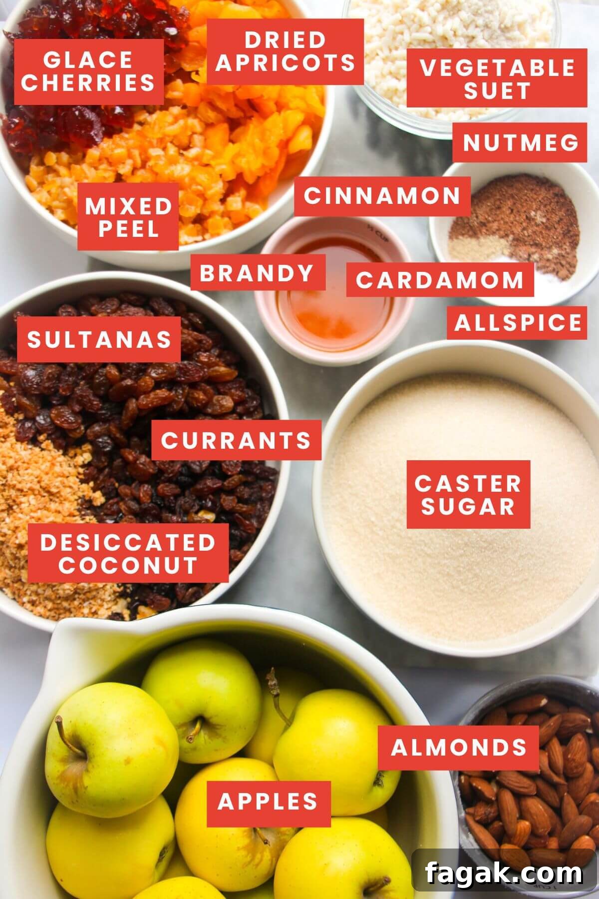 Ingredients for fruit mince laid out on a grey marble background and labelled.