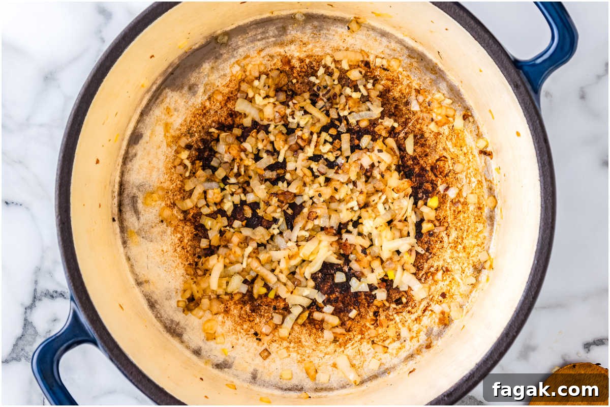 Onions and garlic saute in a pan.