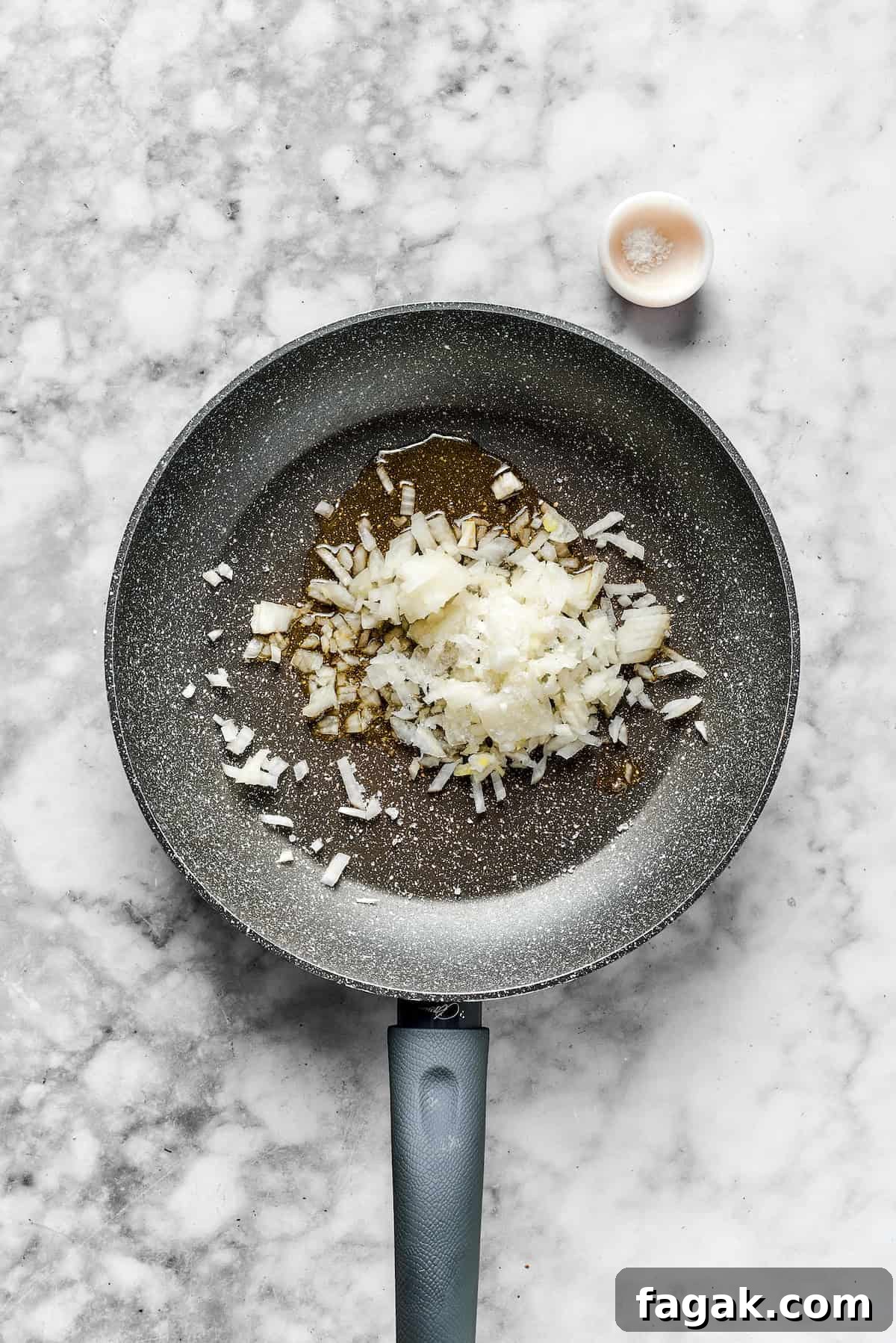 Onions in a skillet ready to cook. 