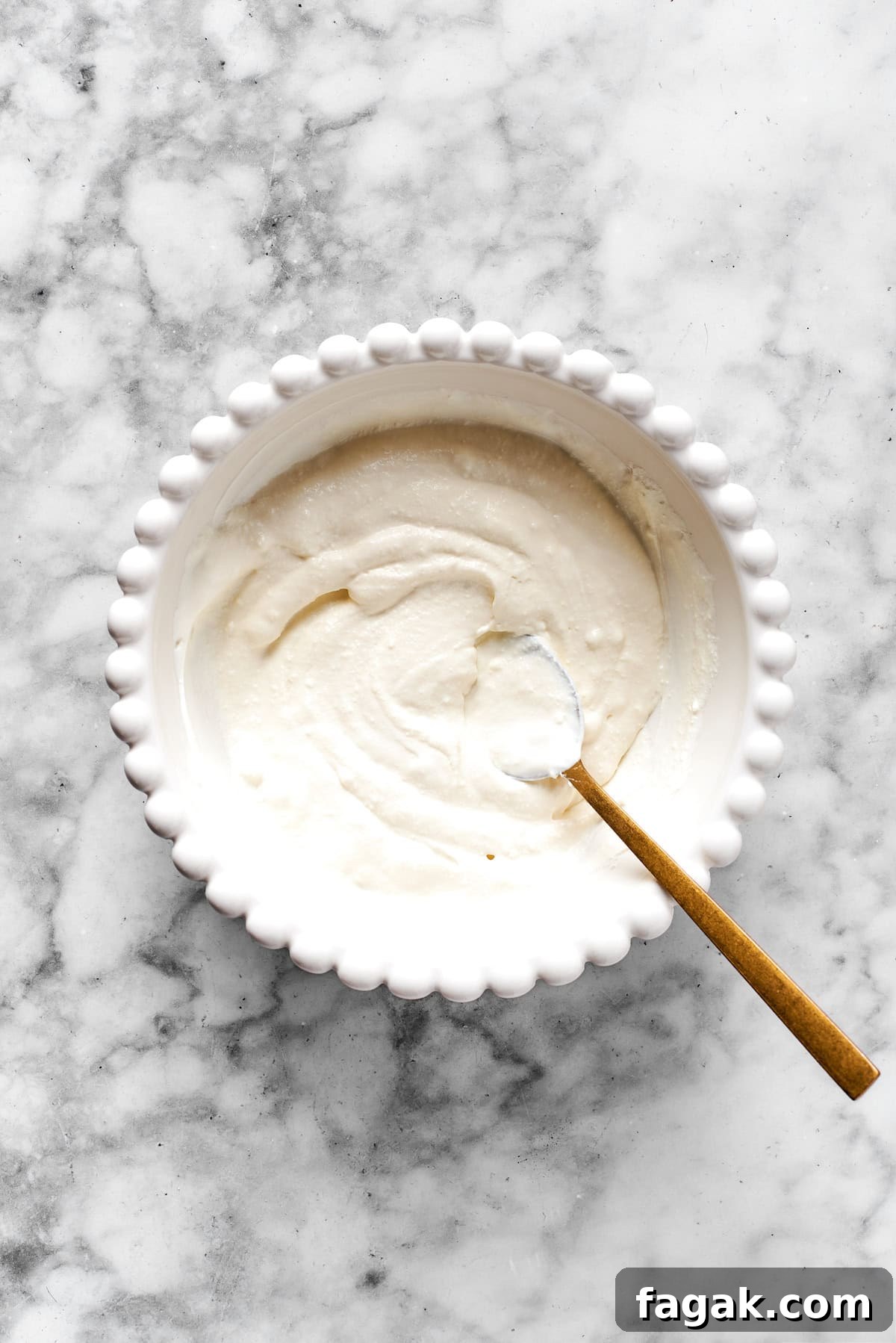 Finished cheese mixture in a white bowl.