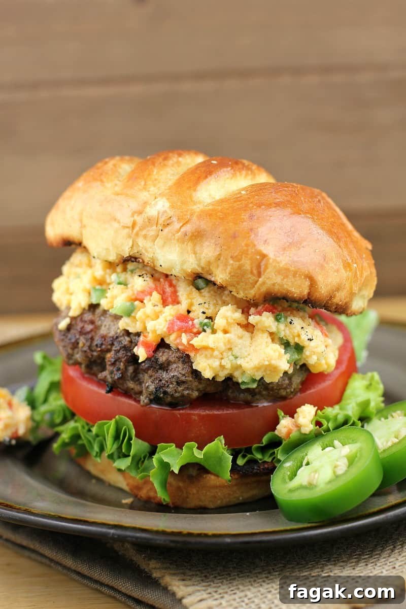 burger on a plate topped with pimento cheese