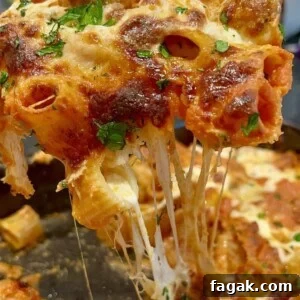 Close-up of a gooey, cheesy baked pasta dish.