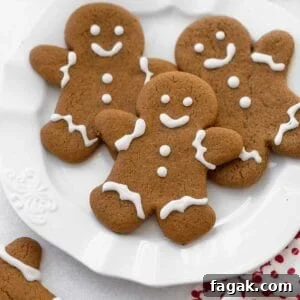 gluten free gingerbread cookies on white plate with glass of milk