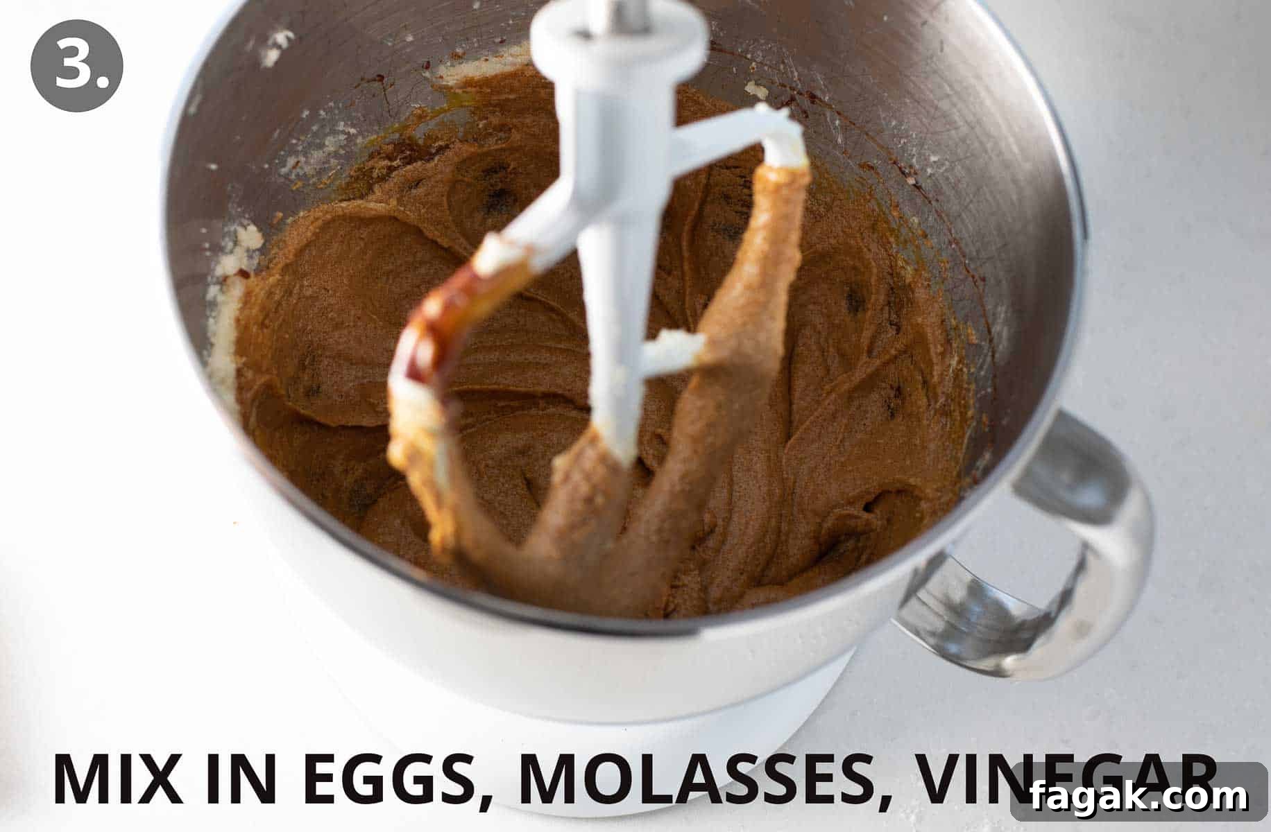 mixing in the wet ingredients in the bowl of a stand mixer.