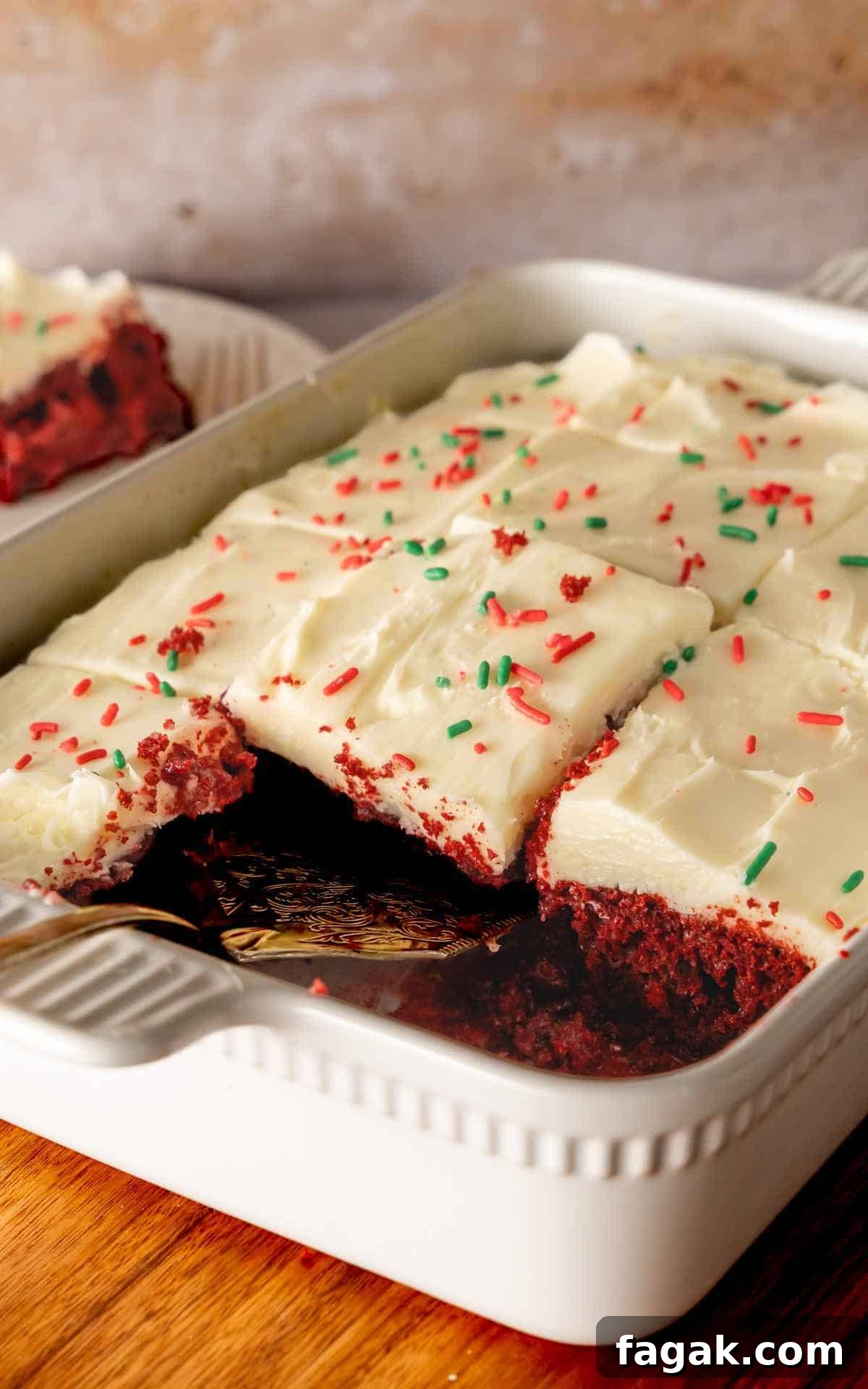 Side view of slices taken out of Christmas red velvet poke cake.