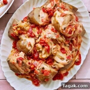 Cheesy Potatoes, also known as Papas Chorreadas on a white serving plate.