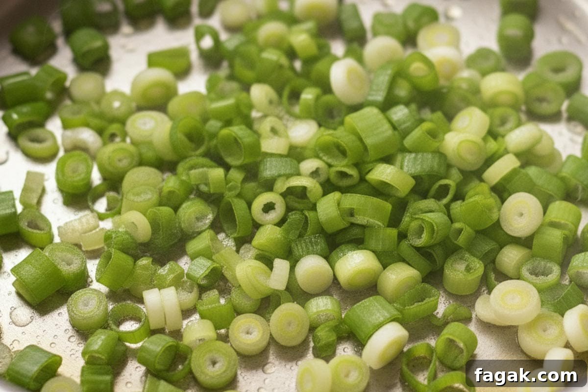 Chopped green onions in a saucepan.