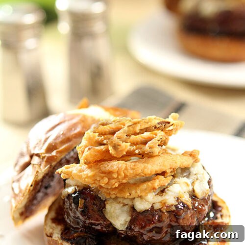 Lamb Burger with Goat Cheese and Onion Rings topped with a Cabernet BBQ Sauce