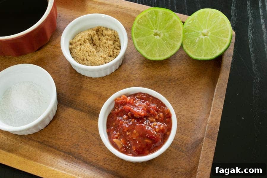 Chili lime jerky ingredients, lime, chili garlic, brown sugar on cutting board