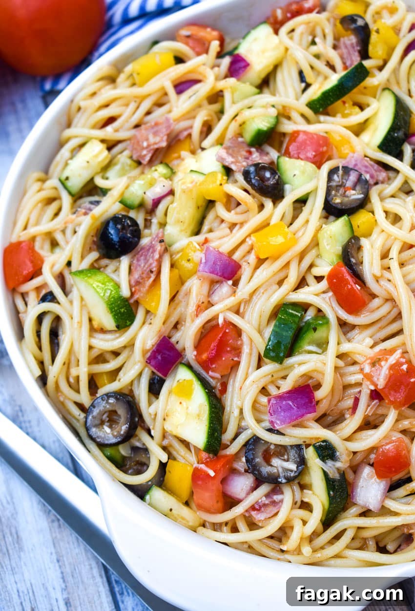 cold spaghetti salad in a white serving bowl